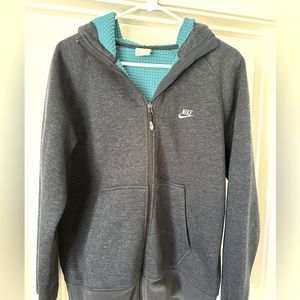 Nike mens sweatshirt in size medium. Zip up feature with blue inner lining.